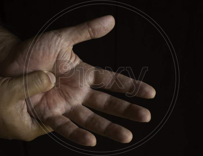 Adult Man With Pain In His Hands. Automassage Of Hands To Relieve Pain.