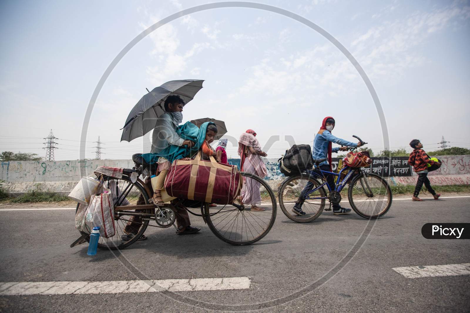 Migrant Worker Kamlesh  Peddling Back To His Village In Sagar District Of Madhya Pradesh With His Children Anushka 7, And Krishna, 4, In New Delhi, India, On May 11, 2020.Distance Between New Delhi To Sagar Is Approximately 680 Kilometres.