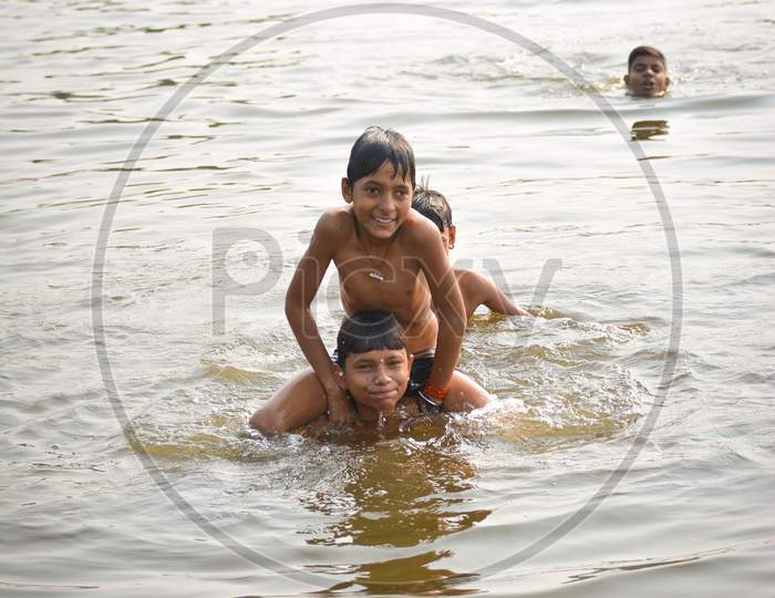 TIKAMGARH, MADHYA PRADESH, INDIA - NOVEMBER 13, 2019: Indian village boys swimming in the fresh river water.