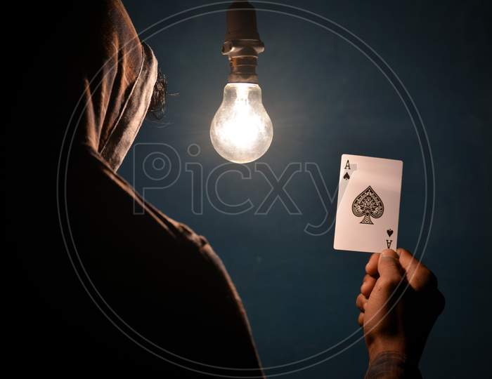 TIKAMGARH, MADHYA PRADESH, INDIA - DECEMBER 15, 2019: Hand holding ace of spades playing card.