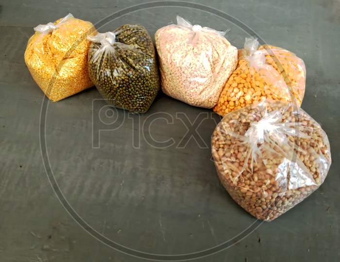 Lentils assorted packets arranged neatly on a wooden table.