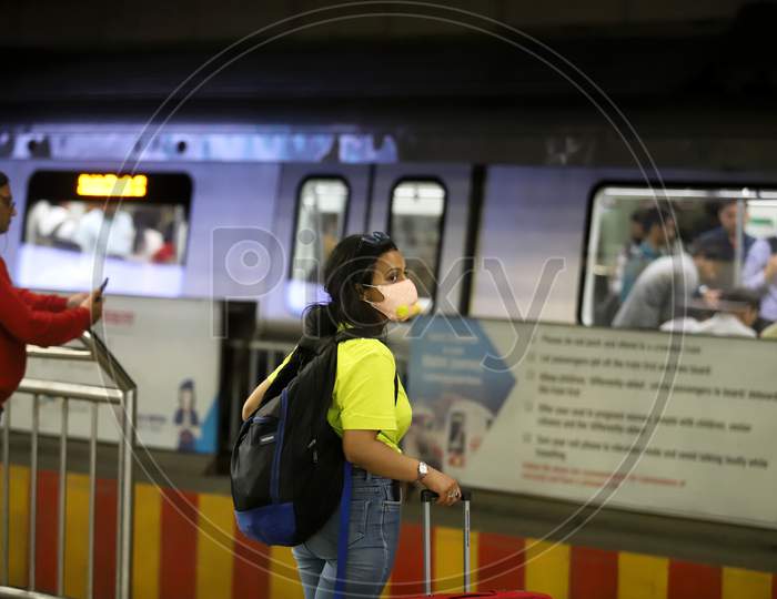 A Woman Wearing A Facemask As A Preventive Measure Against The Covid-19 Novel Coronavirus Walks Out Of A Metro Station In New Delhi On March 13, 2020.
