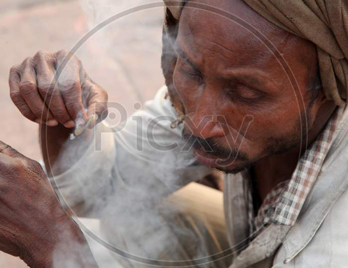 Close up shot of a Person smoking Beedi