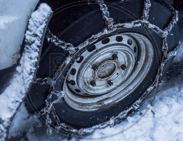 Snow Chains Put On Car Wheel In The Snow, Close-Up - Image