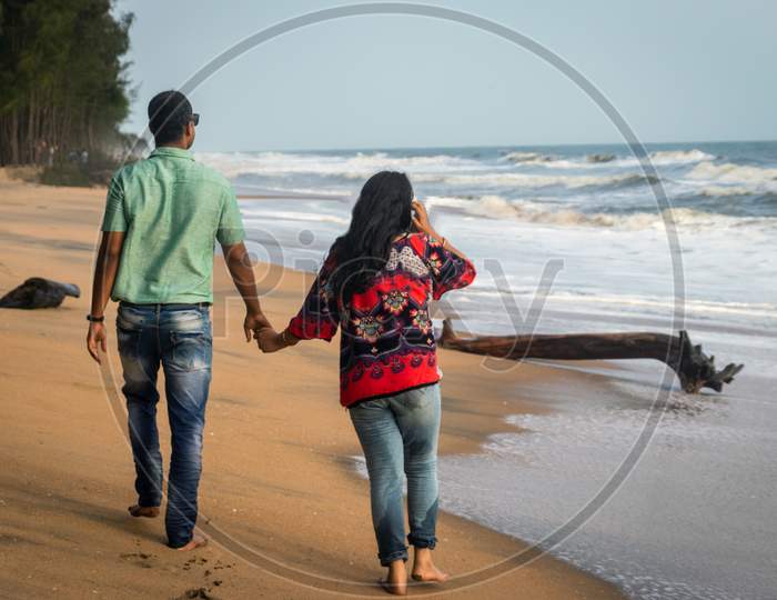 Couple Walking On Sandy Beach With Holding Each Others Hand And Soaking Up The Natural Sea View Image Is Taken At Kochi Kerala India Showing The Love And Affection Of The Couple In The True Nature.