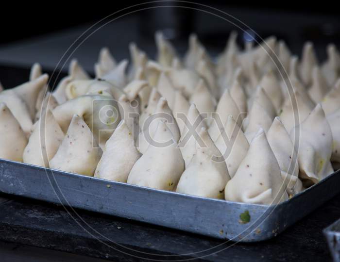 Uncooked Indian Samosa In A Tray Ready To Deep Fry, Spicy, Delicious, Asian Cuisine Concept. - Image