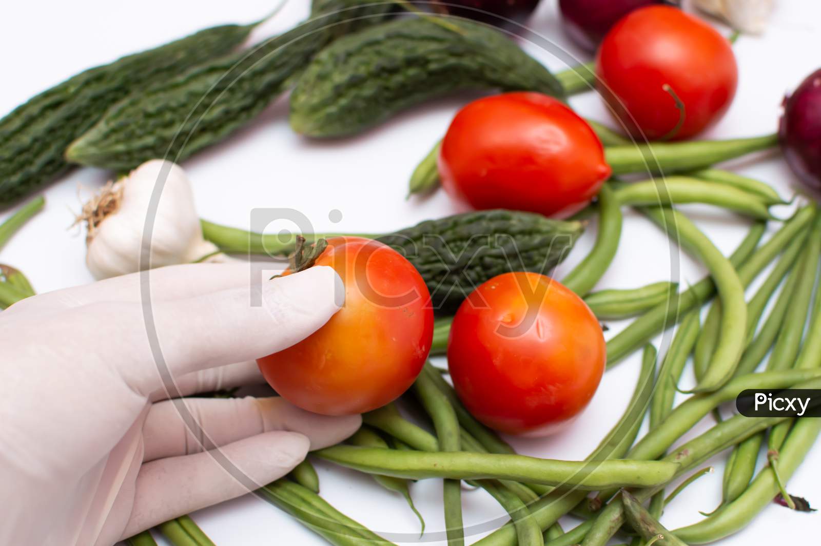 hand protecting from virus picking vegetables and fruits