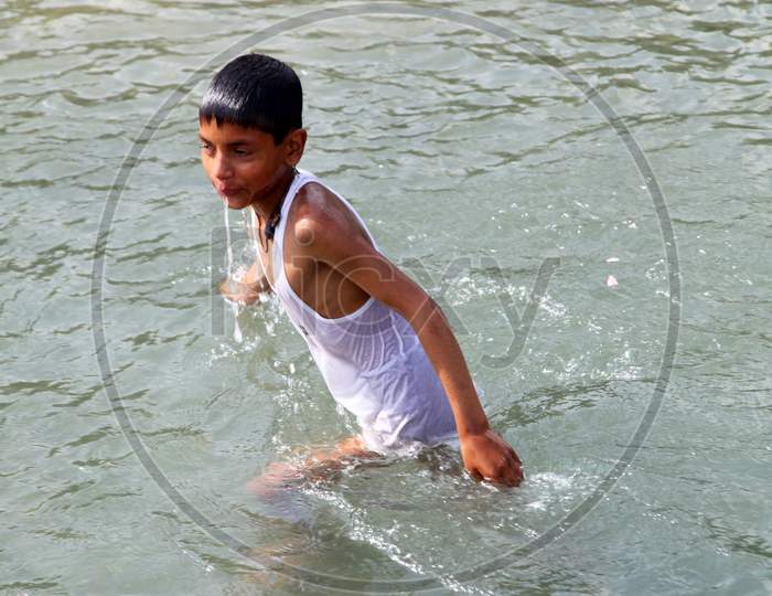 An Indian Kid in Water