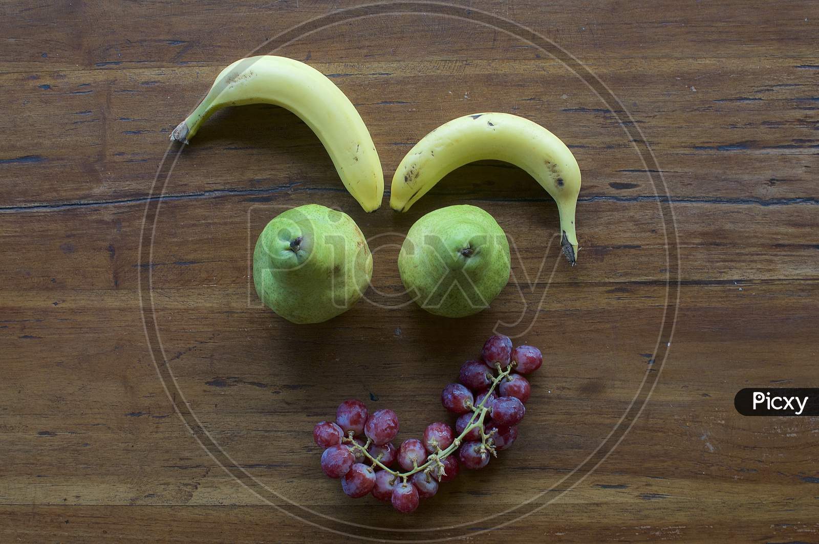 A Smiling Face Made Out Of Various Fruits