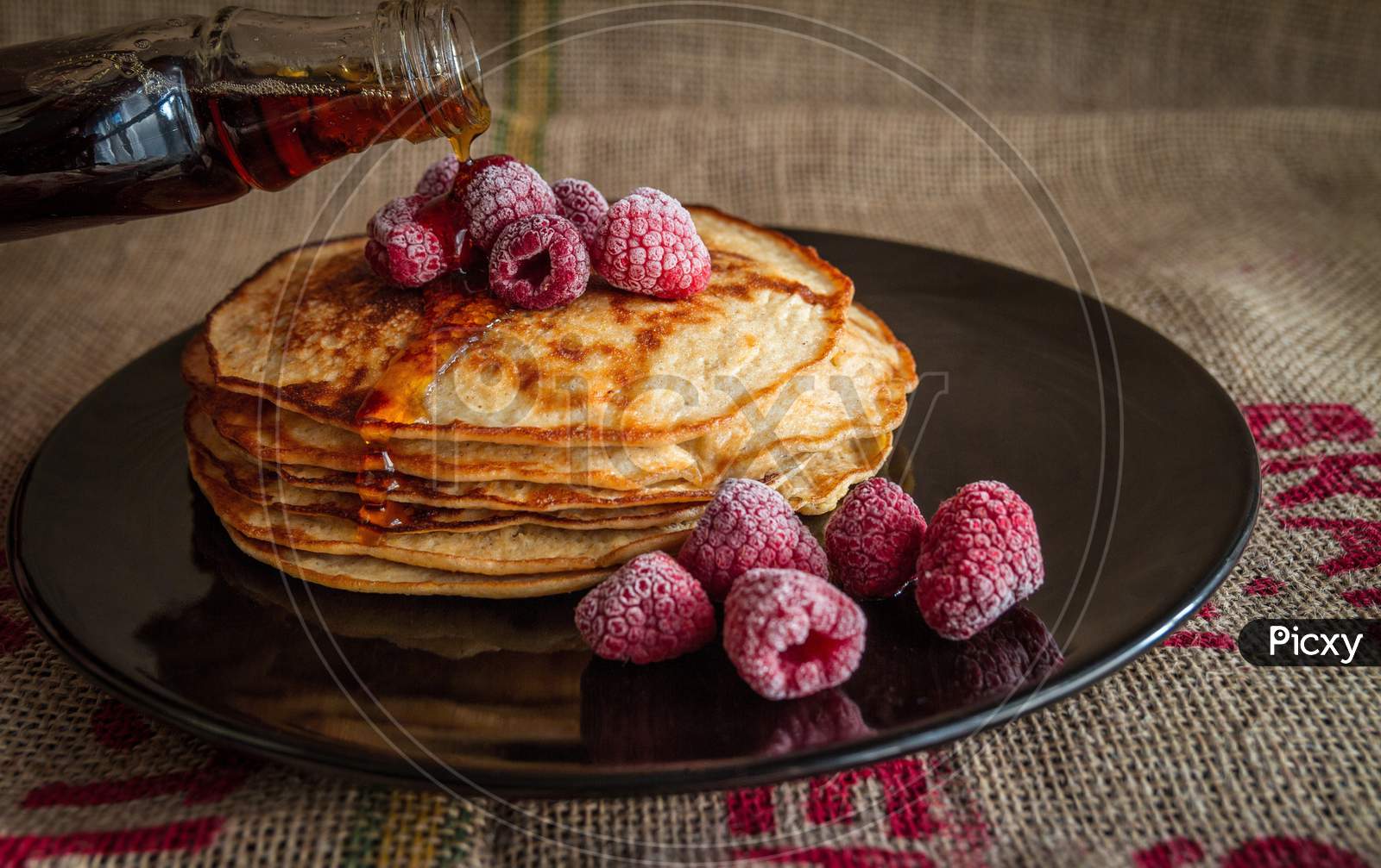 Delicious Healthy breakfast of Pancake with raspberry and honey