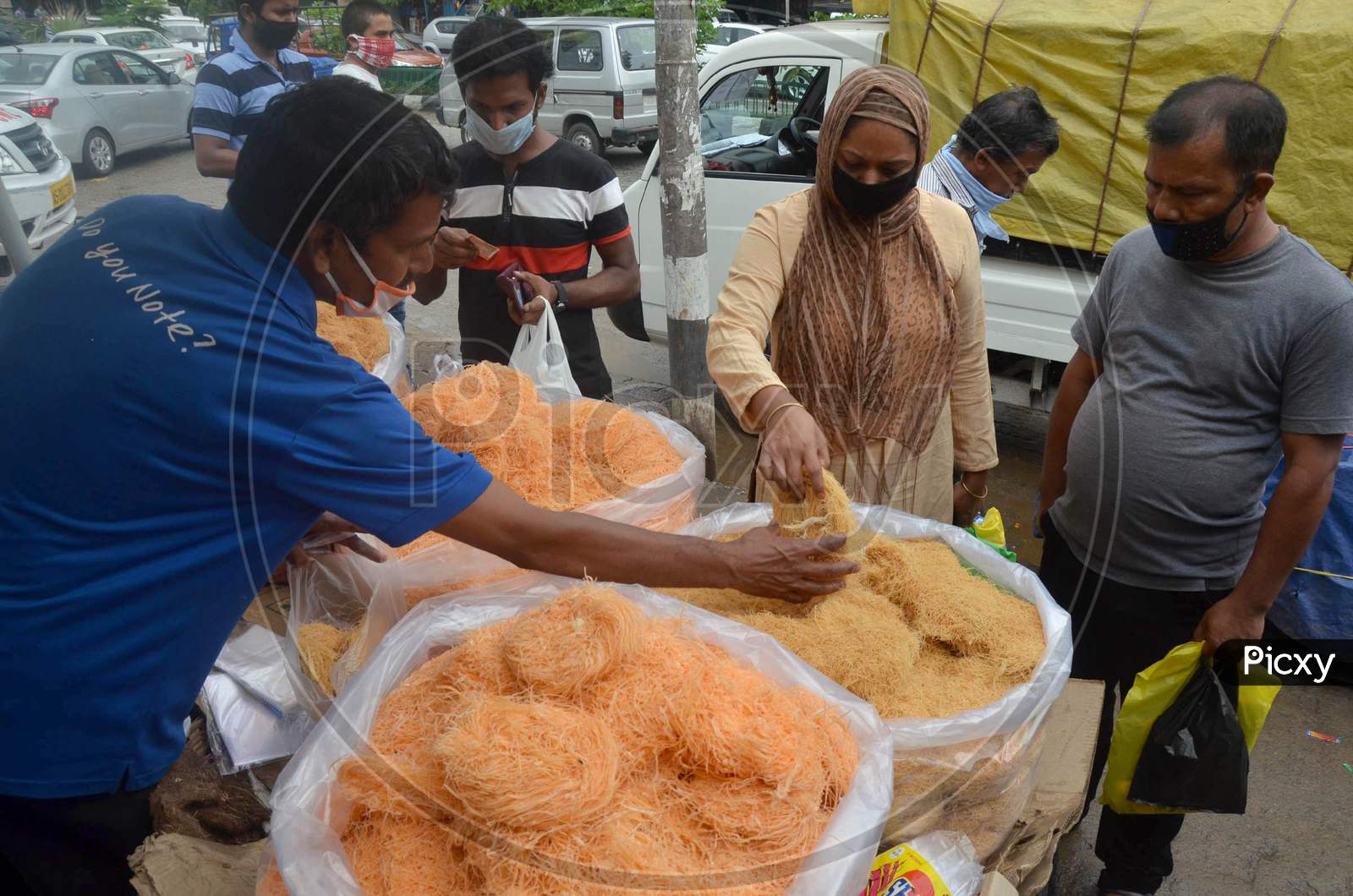 People Wearing Face Mask And Buying Vermicelli From A Roadside Shop Ahead Of Eid-Ul-Fitr, During The Fourth Phase Of Ongoing Covid-19 Nationwide Lockdown, In Guwahati On Saturday, May 23, 2020.