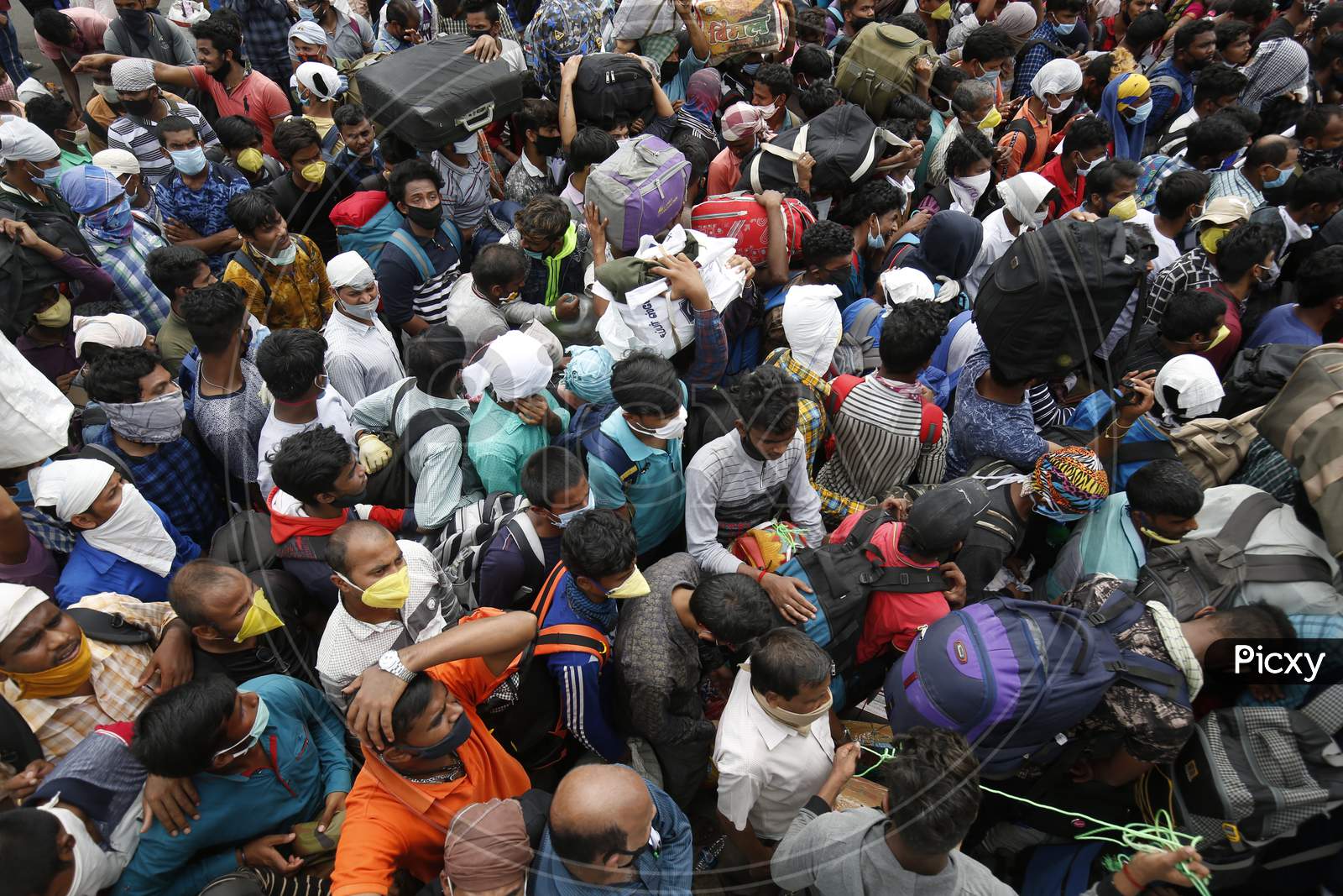 Migrant workers from Odisha wait for a health screening before boarding buses to be taken to a government-arranged train to their destination after the state eased lockdown regulations during the extended nationwide lockdown to prevent the spread of coronavirus (Covid-19) in Bangalore, India.