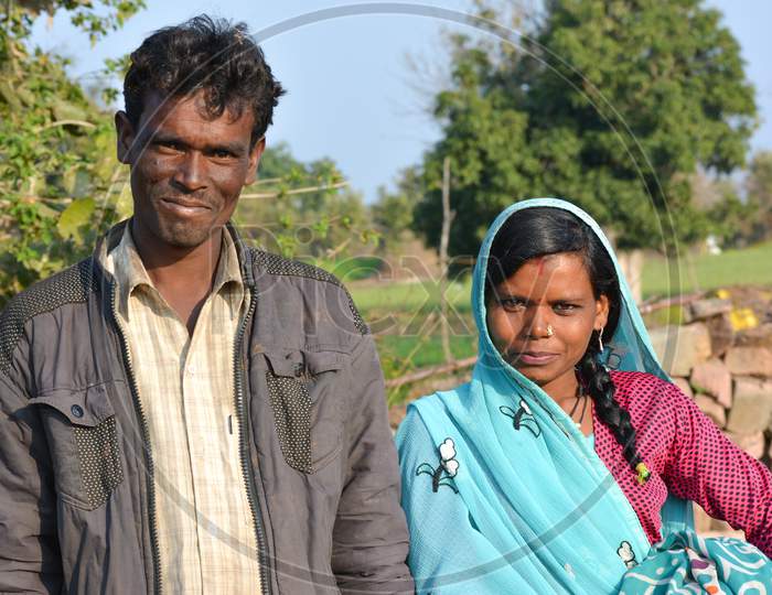 TIKAMGARH, MADHYA PRADESH, INDIA - FEBRUARY 08, 2020: Young indian village man and woman couple smiling and looking at the camera.