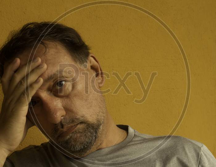 Middle-Aged White Man With Depression Or Anxiety. Feeling Of Mental Exhaustion.