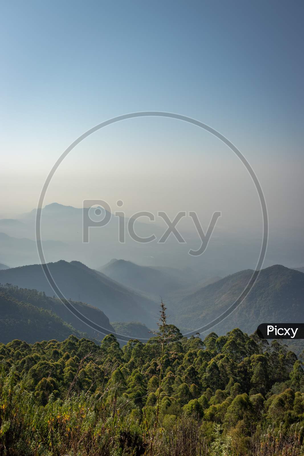 Mountain Range In Mist With Amazing Blue Sky