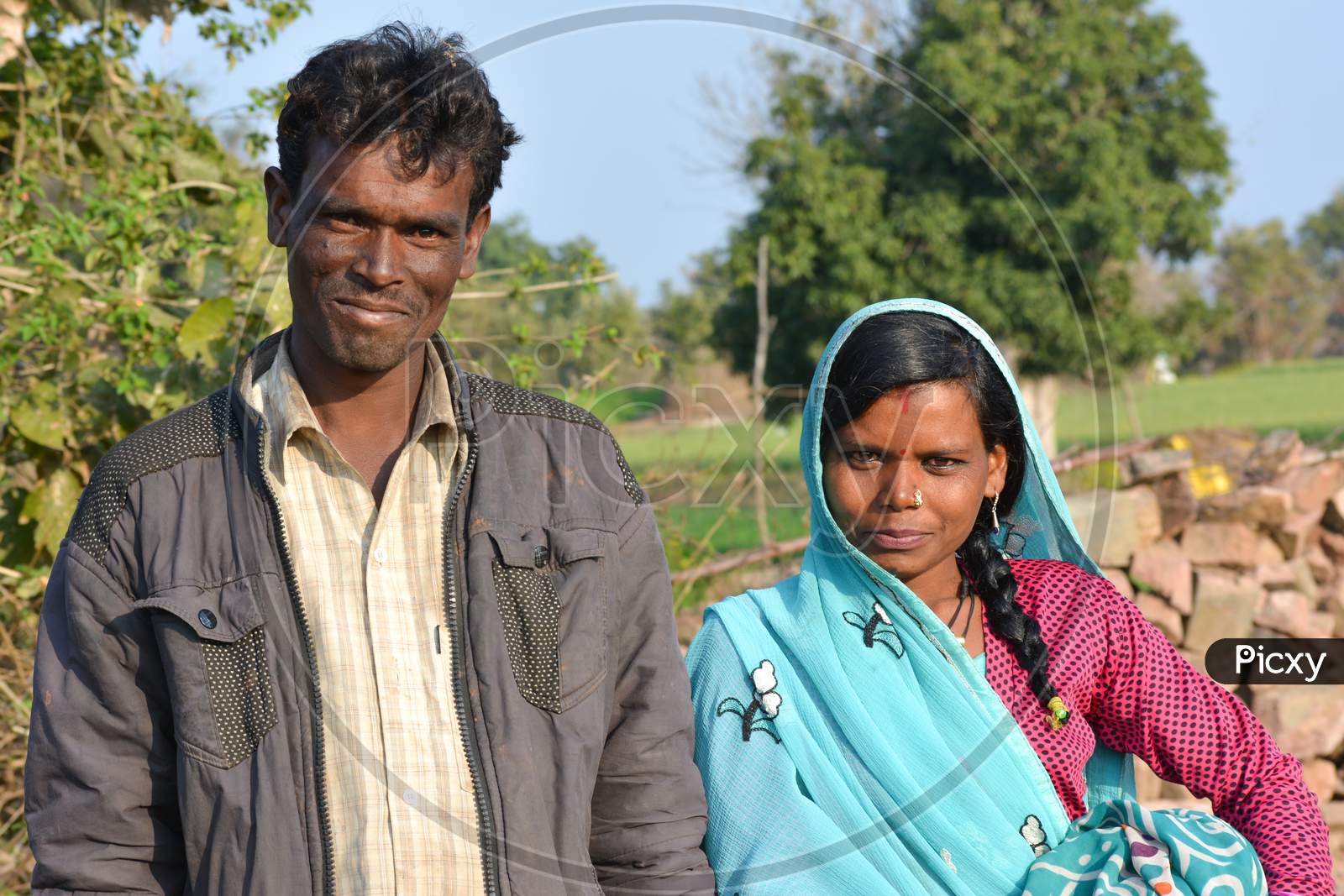 TIKAMGARH, MADHYA PRADESH, INDIA - FEBRUARY 08, 2020: Young indian village man and woman couple smiling and looking at the camera.