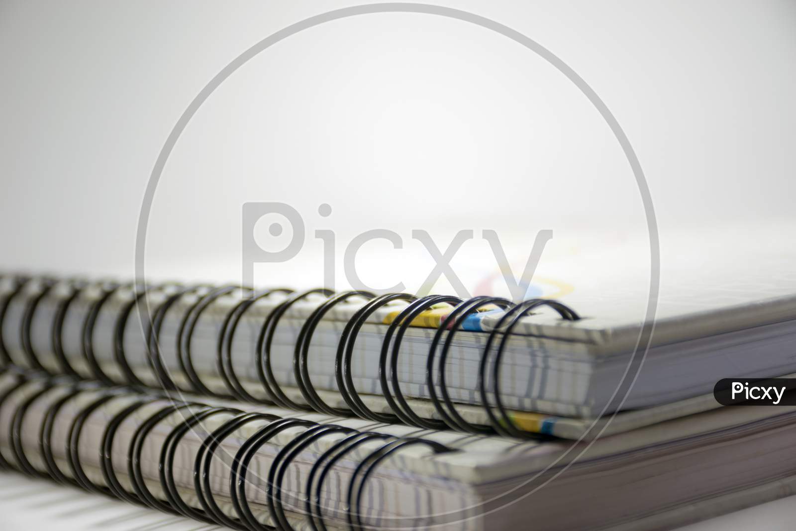 A Close View Of Diaries With Rings Isolated On A White Background