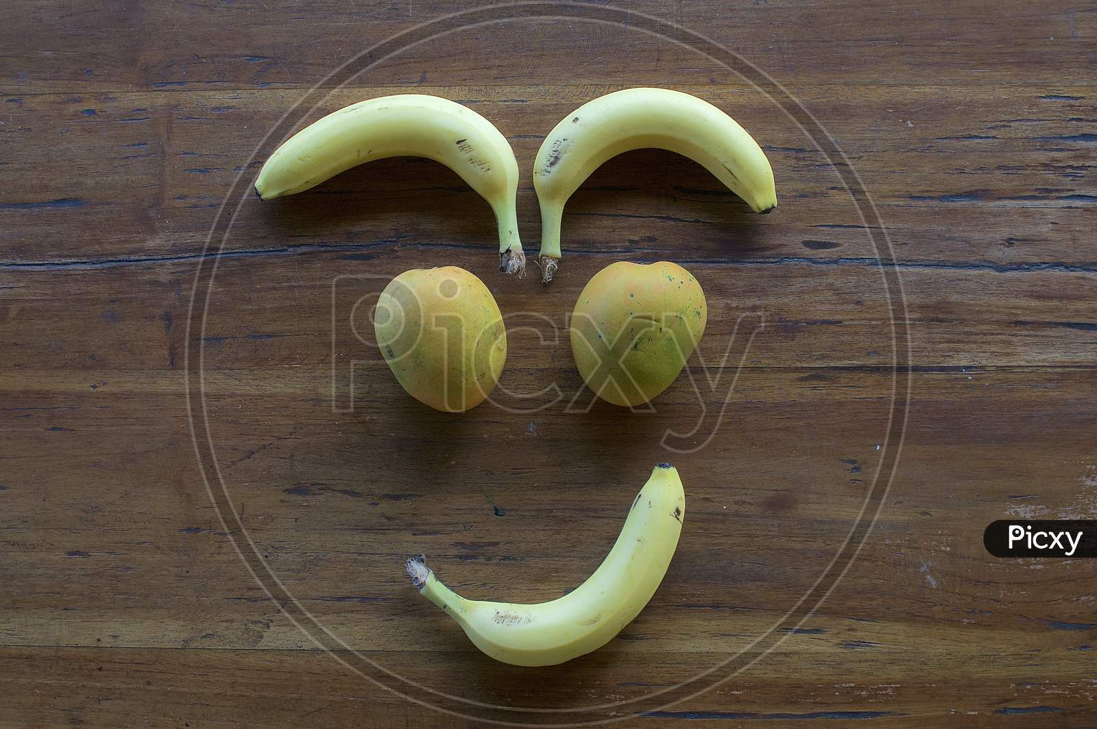 A Smiling Face Made Out Of Various Fruits