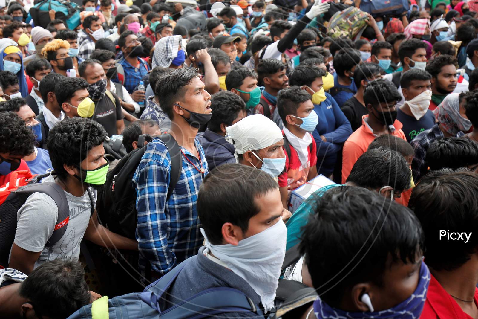 Migrant workers from Odisha wait for a health screening before boarding buses to be taken to a government-arranged train to their destination after the state eased lockdown regulations during the extended nationwide lockdown to prevent the spread of coronavirus (Covid-19) in Bangalore, India.