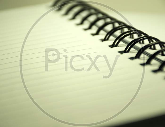 A Close View Of An Open Diary Or Notepad With Rings Isolated On A White Background