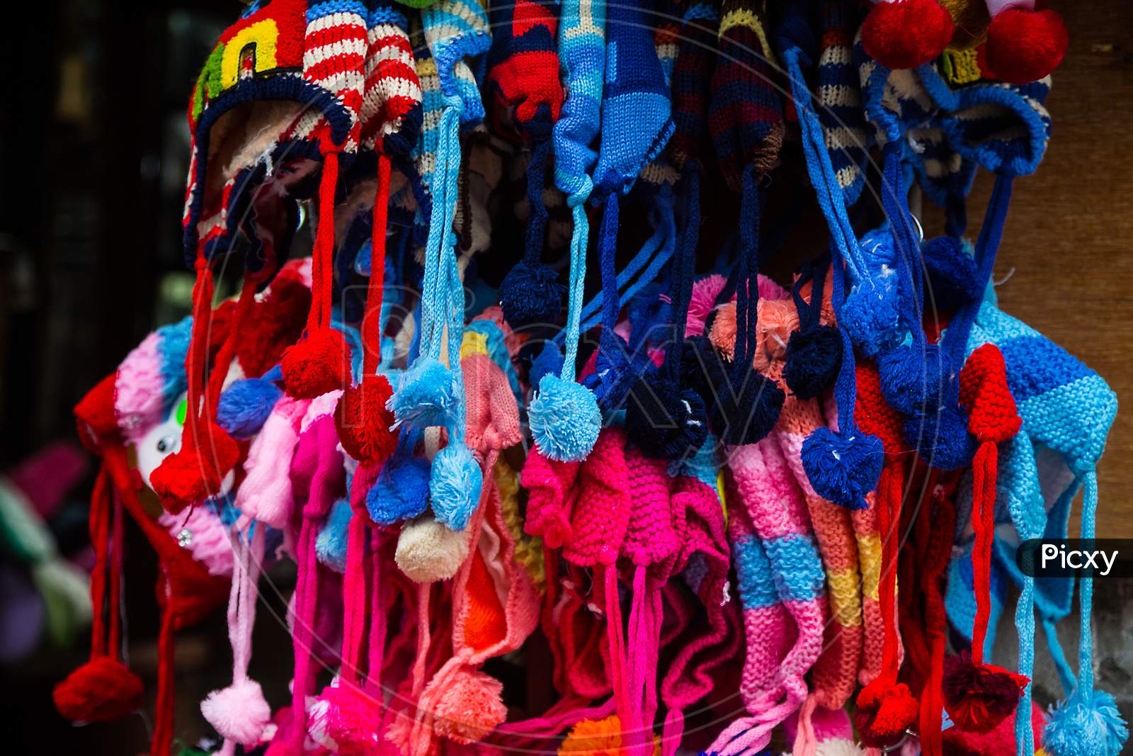 Colorful Knitted Winter Caps And Scarfs Hanging Outside The Shop, Background, Market - Image