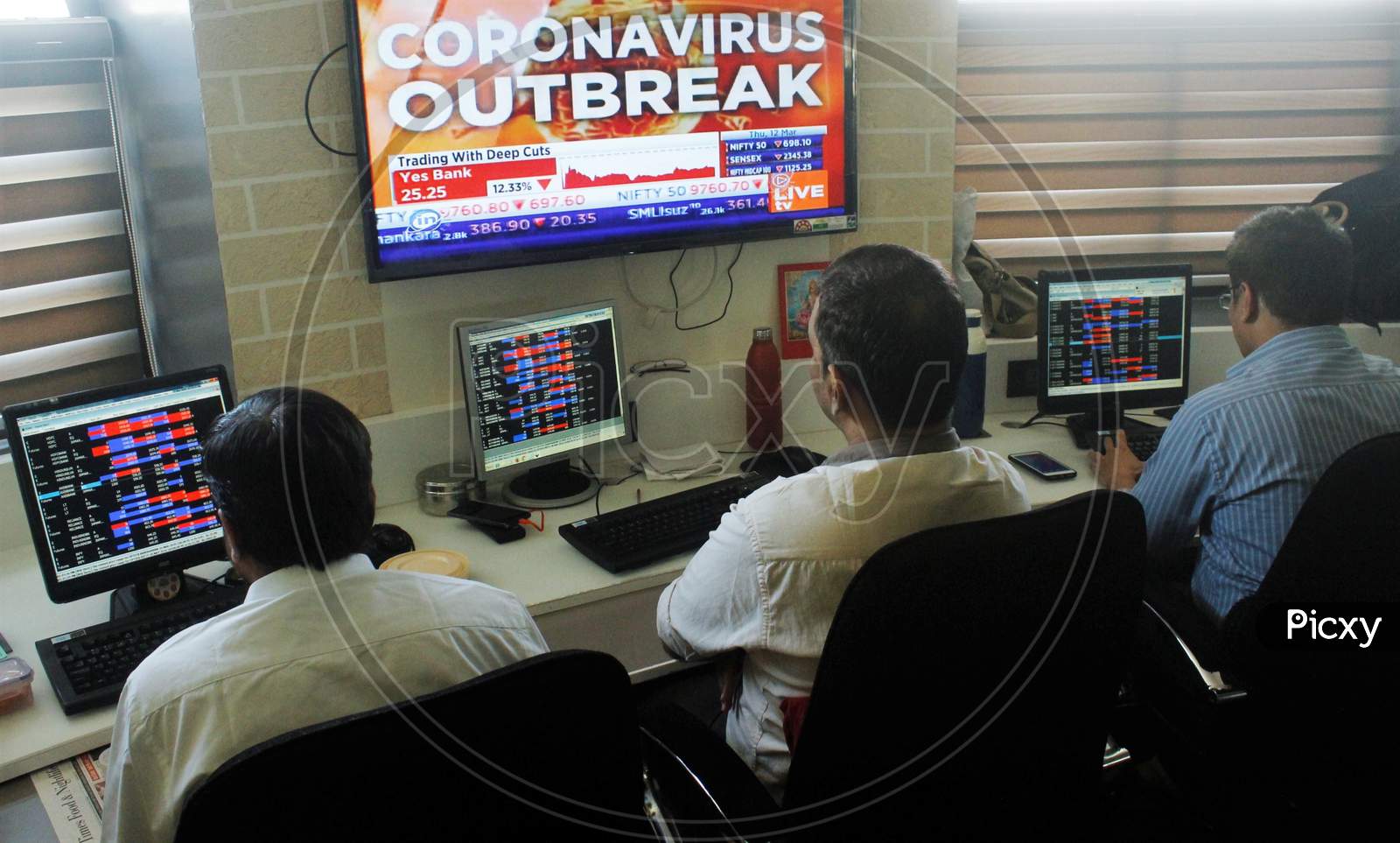 Brokers work at their computer terminal at a stock brokerage firm following the coronavirus outbreak, in Mumbai, India on March 12, 2020.