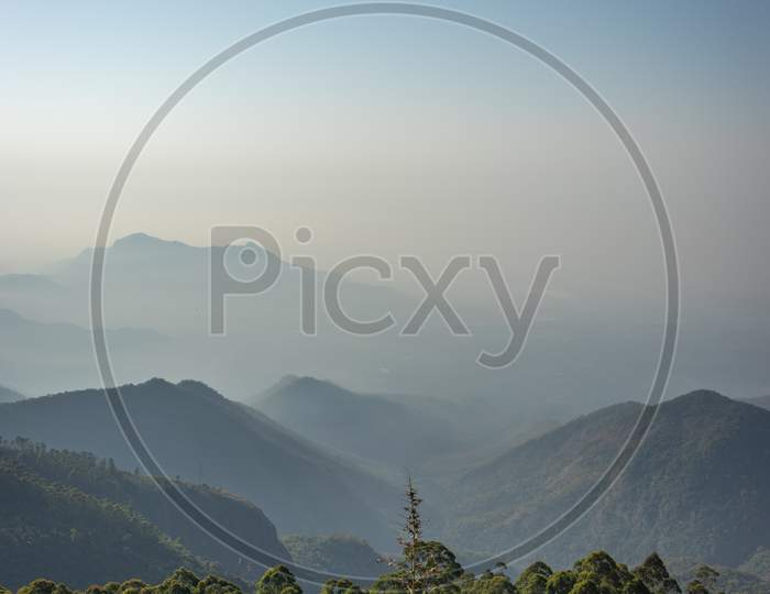 Mountain Range In Mist With Amazing Blue Sky