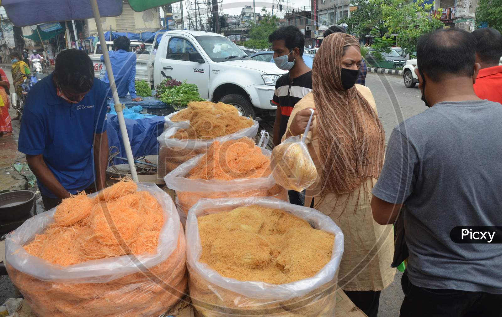 People Wearing Face Mask And Buying   Vermicelli From A Roadside Shop Ahead Of Eid-Ul-Fitr, During The Fourth Phase Of Ongoing Covid-19 Nationwide Lockdown, In Guwahati On Saturday, May 23, 2020.