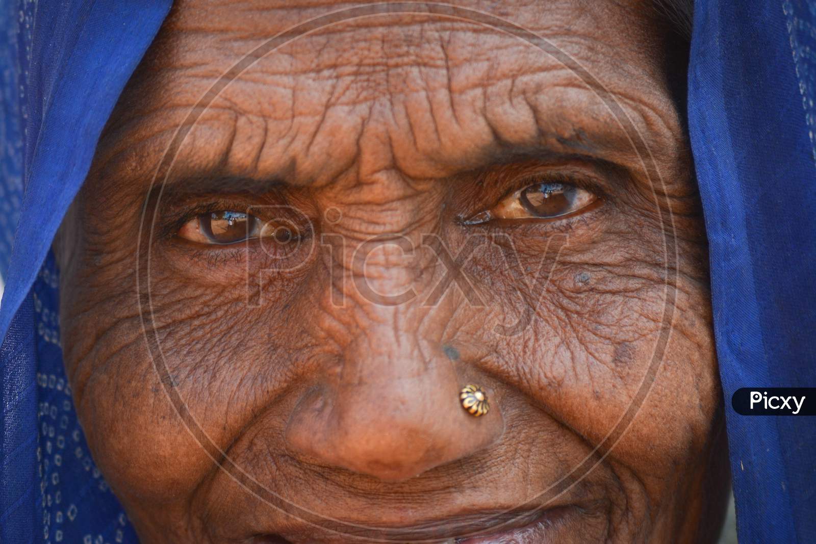 TIKAMGARH, MADHYA PRADESH, INDIA - FEBRUARY 08, 2020: Closeup shot of the eyes of an old indian woman staring at the camera.