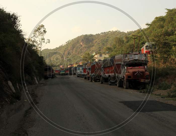 Heavy Vehicles parked on a Single Lane Road