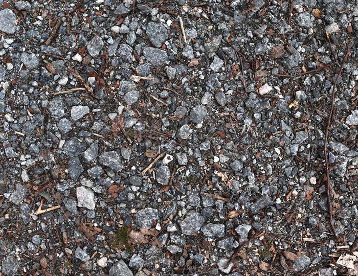 Detailed close up view on pebbles and stones on a gravel ground texture in high resolution