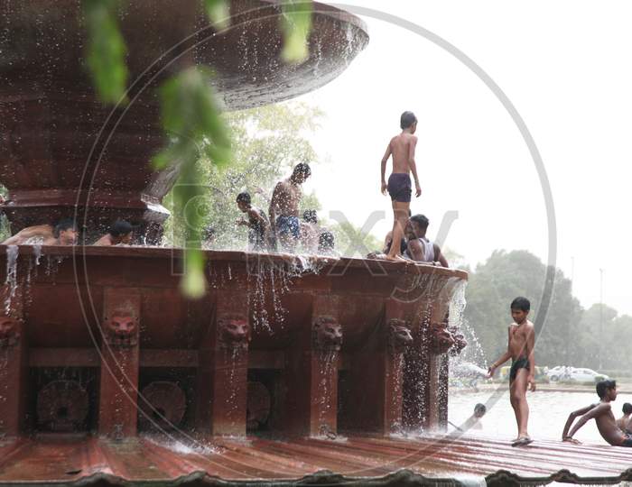 People bathing near a Water Fountain