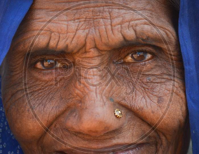 TIKAMGARH, MADHYA PRADESH, INDIA - FEBRUARY 08, 2020: Closeup shot of the eyes of an old indian woman staring at the camera.