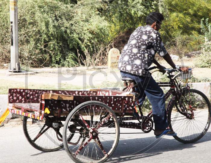 A Man moving on a Rickshaw