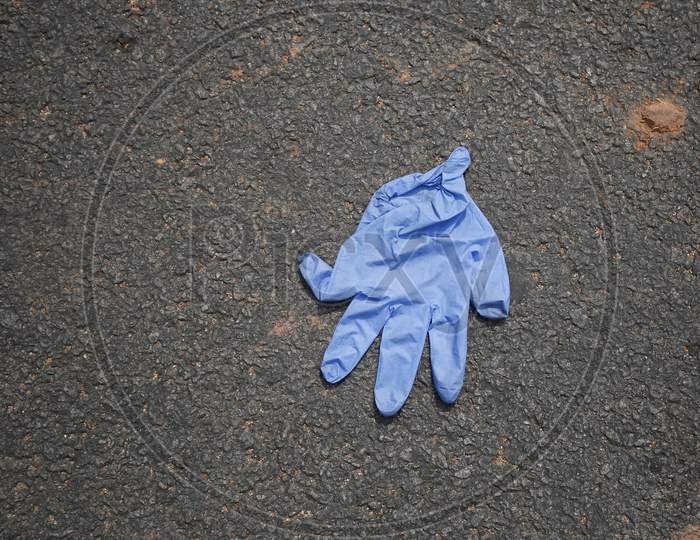 A discarded nitrile glove is seen on a road during the extended nationwide lockdown to prevent the spread of coronavirus (Covid-19) in Bangalore, India.