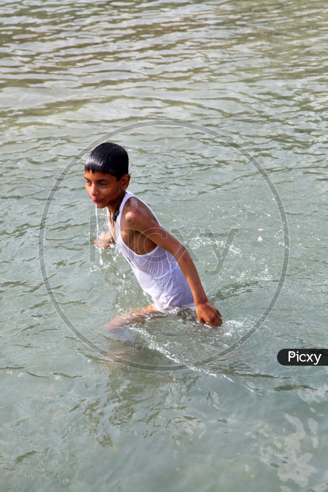 A Young Indian Boy in Water