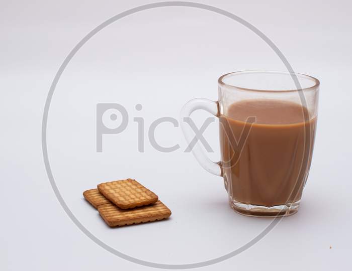 Cup of tea and three biscuits on white sheet