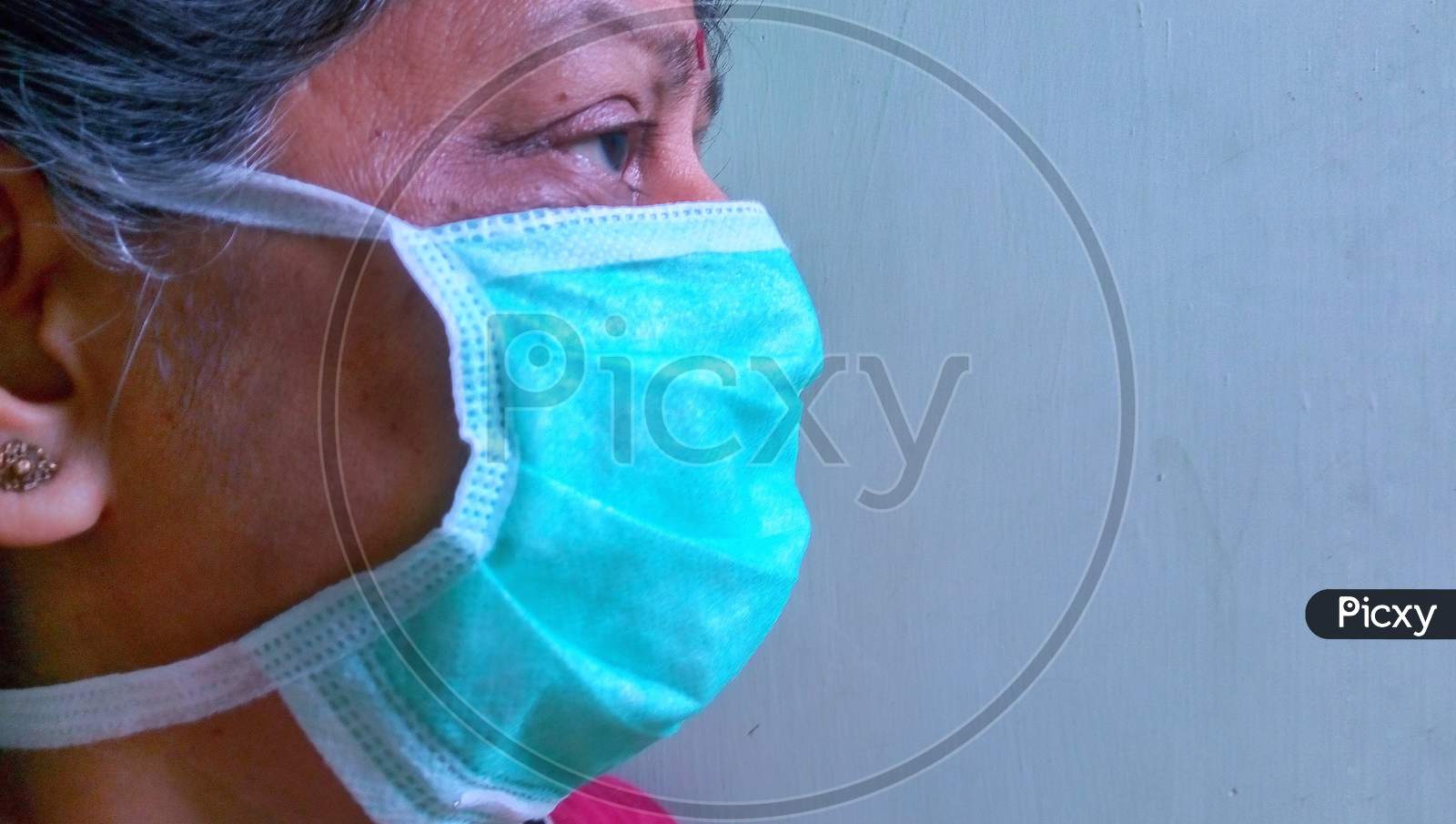 Woman wearing mask Corona mask colour