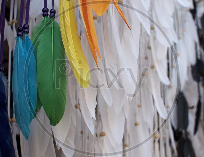 Close Up White And Colored Feathers Of A Dreamcatcher Hanging At Ubud Art Market
