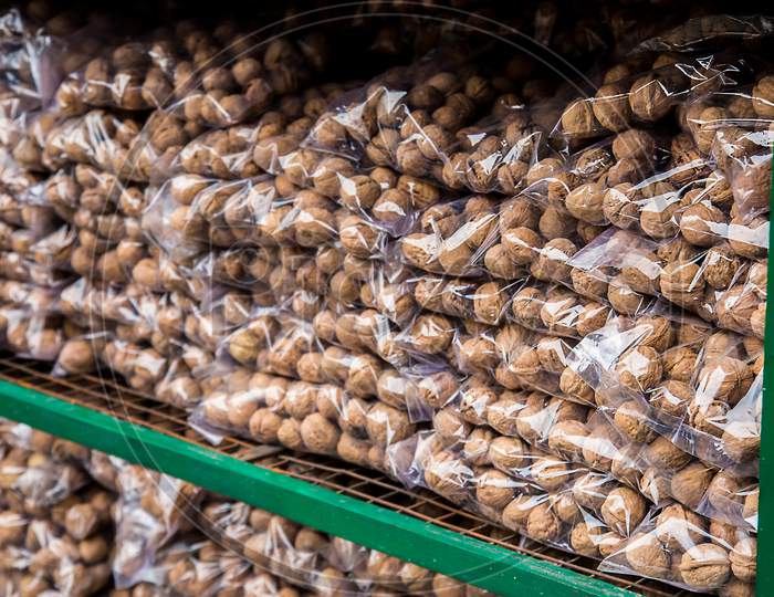 Transparent Plastic Package Full Of Walnuts Stacked In Piles For Sale At Market, Dried Fruits, Asian Market - Image