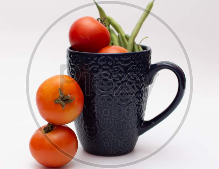Blue mug and vegetables on a white background