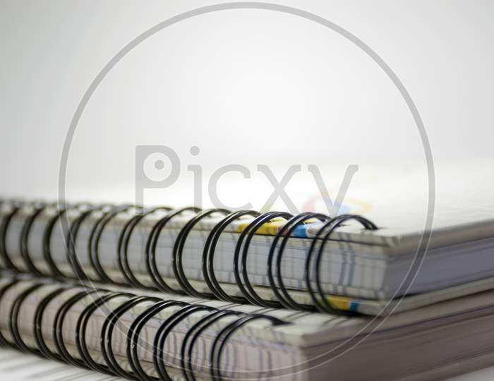 A Close View Of Diaries With Rings Isolated On A White Background