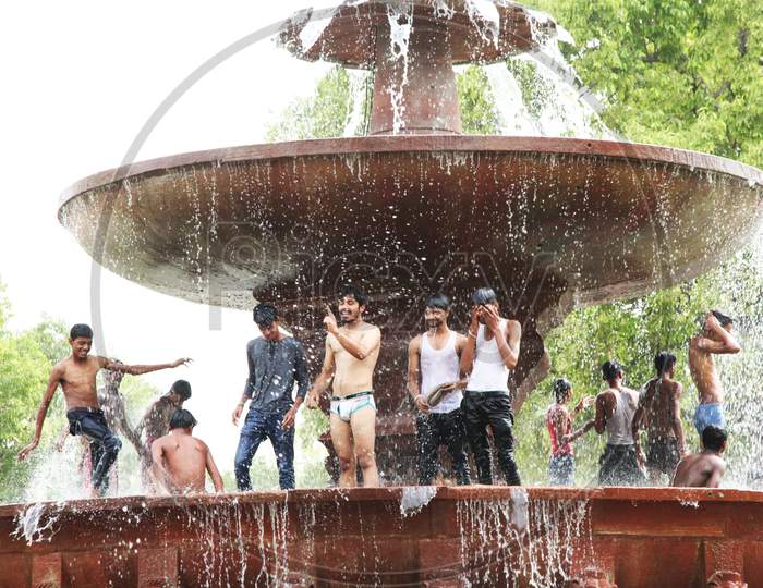 People bathing near a Water Fountain
