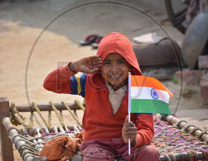 TIKAMGARH, MADHYA PRADESH, INDIA - JANUARY 22, 2020: Unidentified indian village little boy holding indian flag.