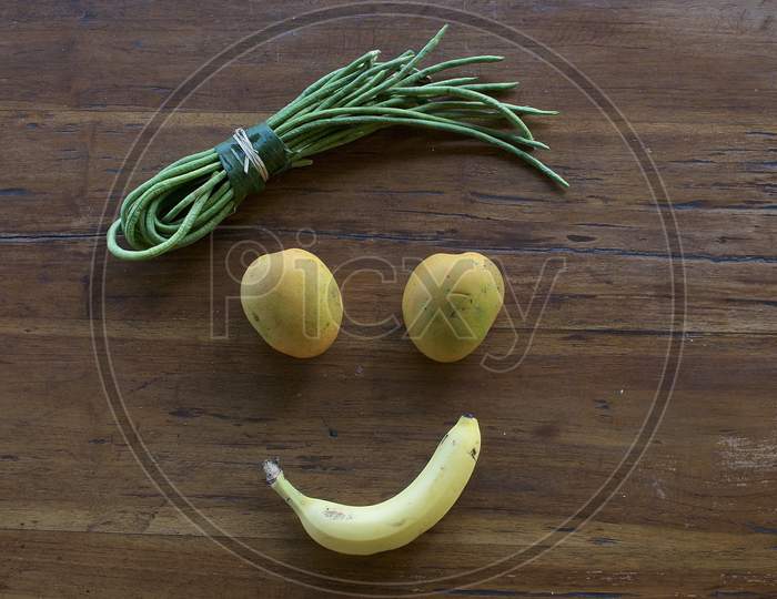 A Smiling Face Made Out Of Vegetables And Fruits