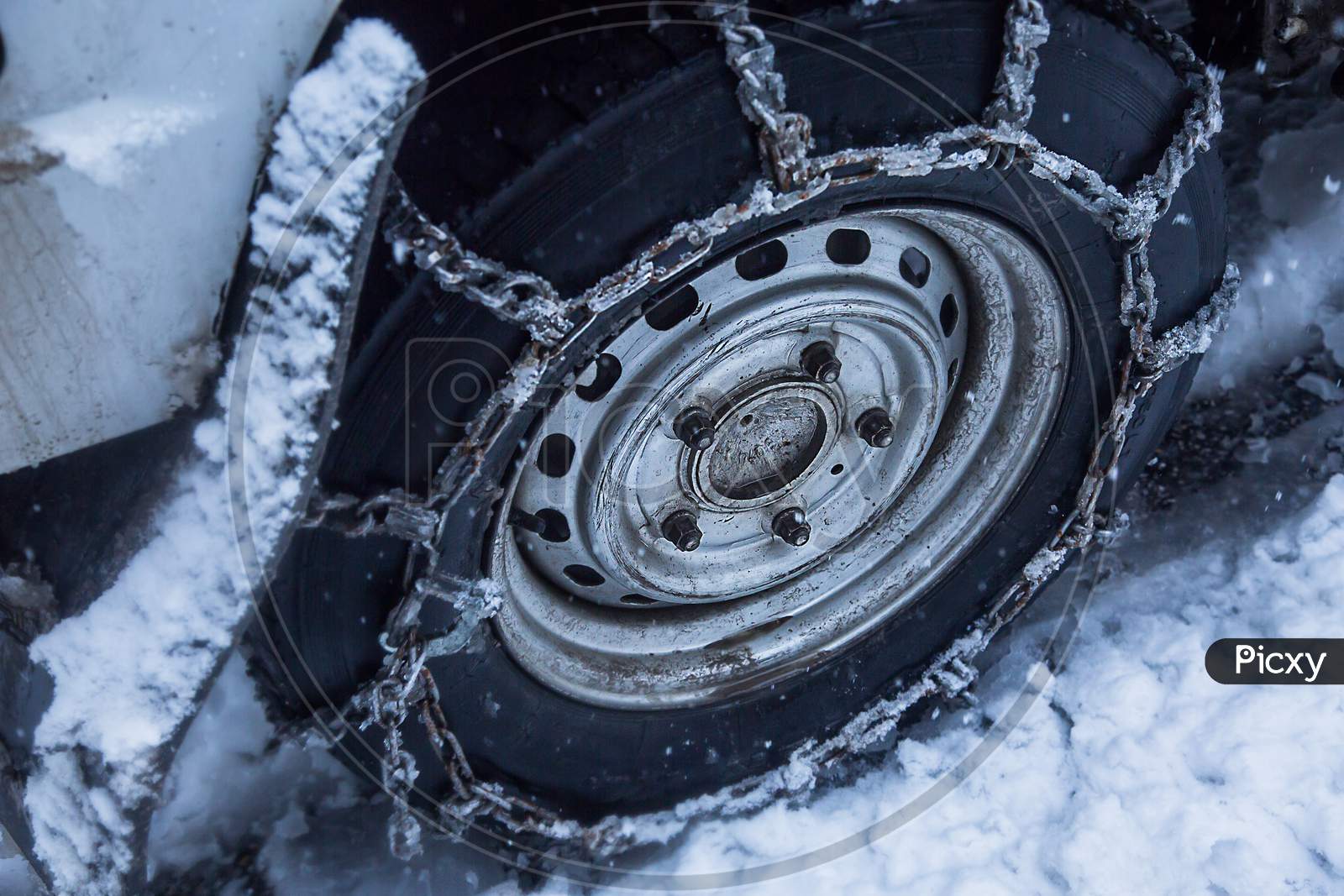 Snow Chains Put On Car Wheel In The Snow, Close-Up - Image