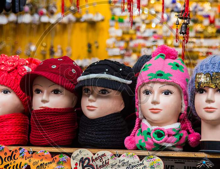 Faces Of Female Mannequins Wearing A Colorful Knitted Woolen Caps And Scarfs In Store, Winter Cloths Concept, Background - Image