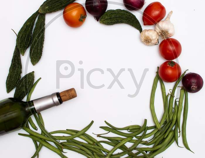 vegetables, fruits and wine placed on a white background