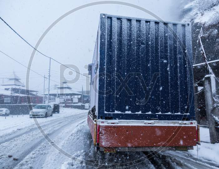 Truck On Dangerous Snowy Road,High Way. Moving In Winter Season, Bad Weather And Transportation Concept - Image