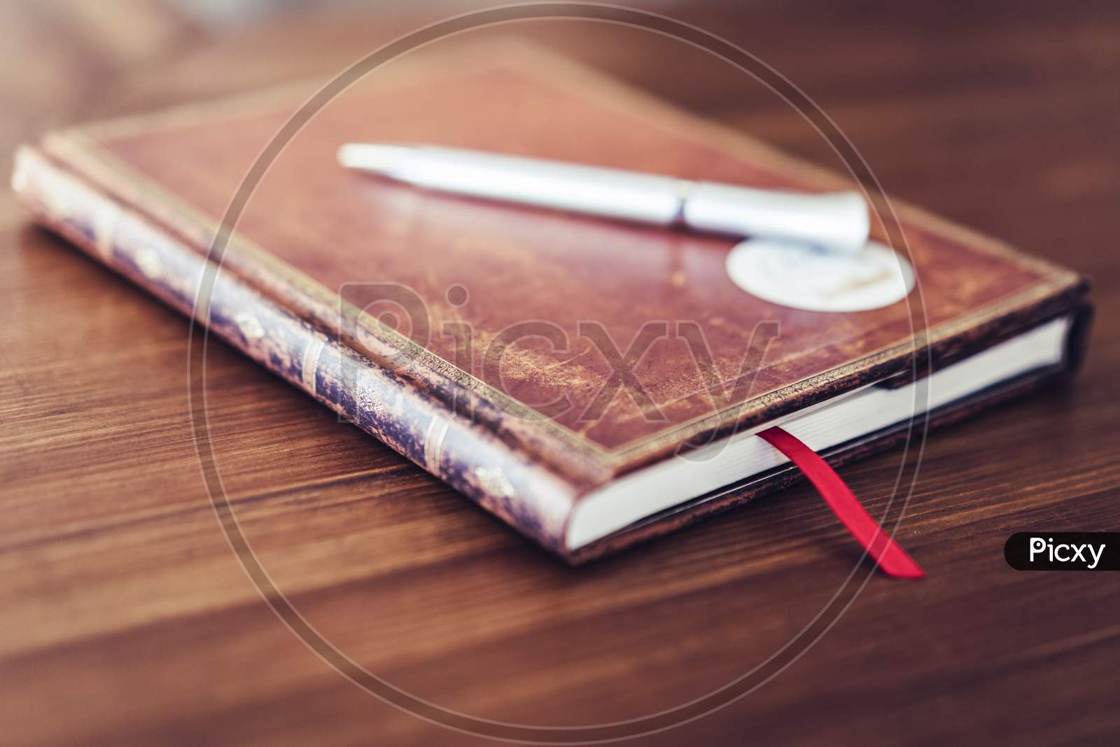 Antique Brown Notebook On Wooden Table With White Pen, Selective Focus